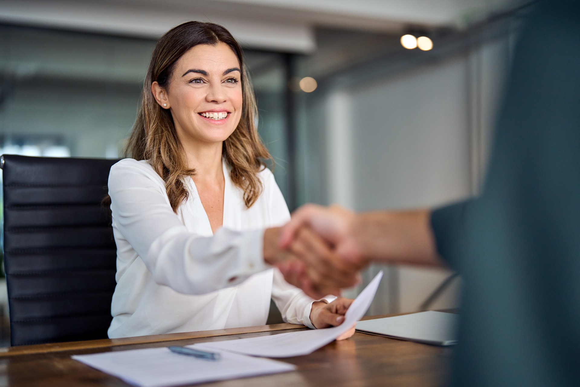 Autism, Neurodiversity, Consulting, Happy mid aged business woman manager handshaking at office meeting.